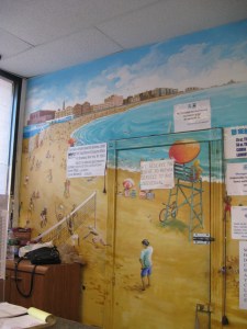 signs on the beach Laundromat signs float above beach volleyball scene.